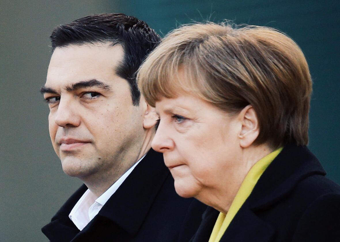 Greek Prime Minister Alexis Tsipras and German Chancellor Angela Merkel listen to their countries’ national anthems upon Tsipras’ arrival for talks at the Chancellery on March 23, 2015, in Berlin.