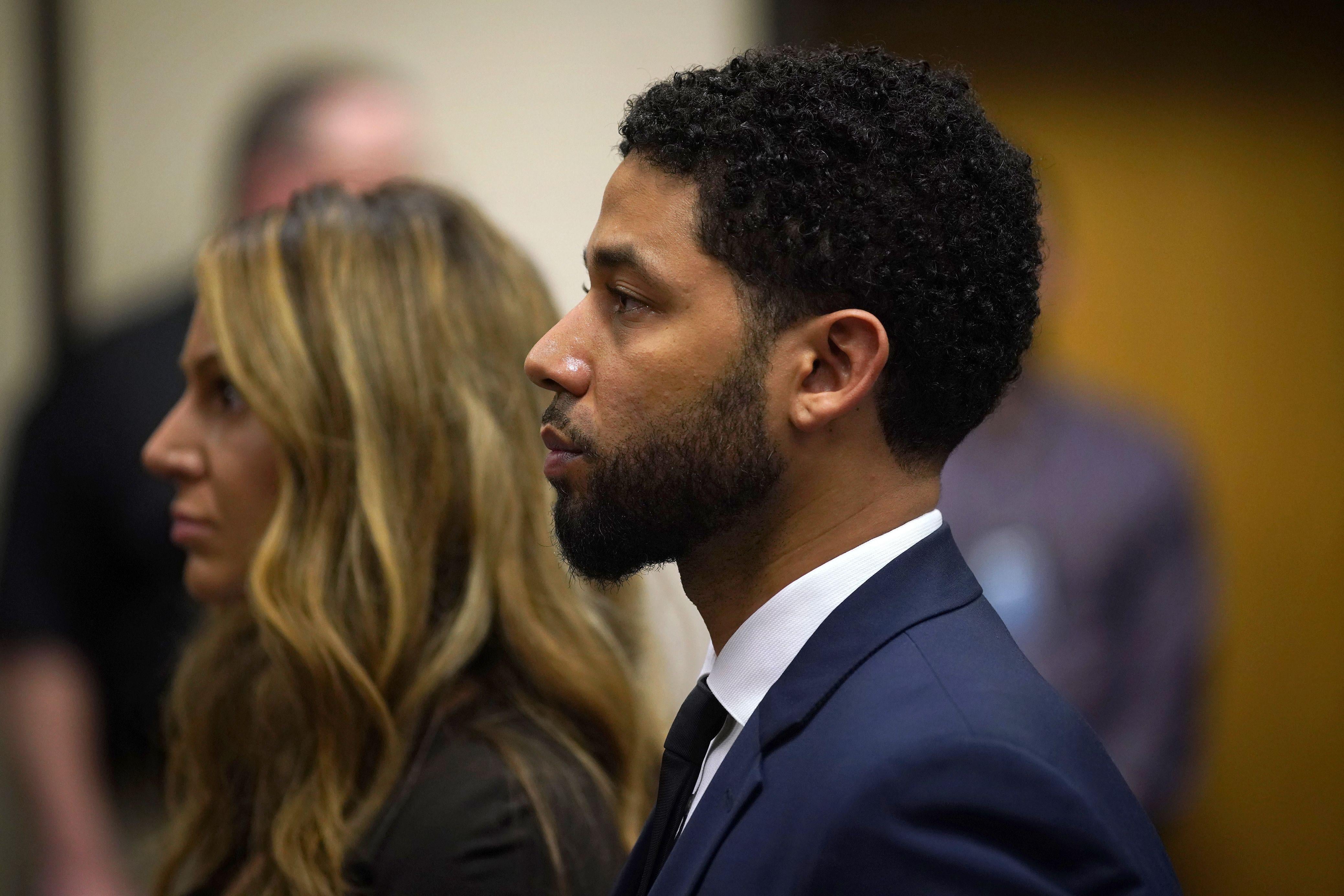 Jussie Smollett seen in profile in a courthouse.