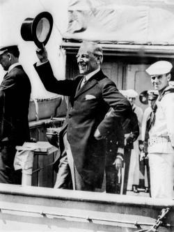 President Woodrow Wilson waves from the deck of the USS George Washington as it steamed into New York Harbor July 9, 1919. 