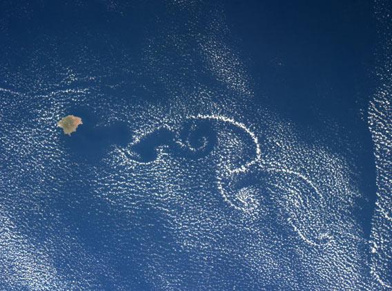 Vortices of clouds swirl as seen from space
