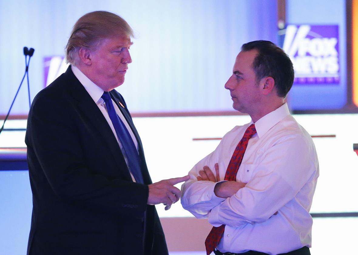 Republican presidential candidate Donald Trump speaks with Reince Priebus, chairman of the Republican National Committee, at a debate sponsored by Fox News at the Fox Theatre on March 3, 2016 in Detroit, Michigan. 