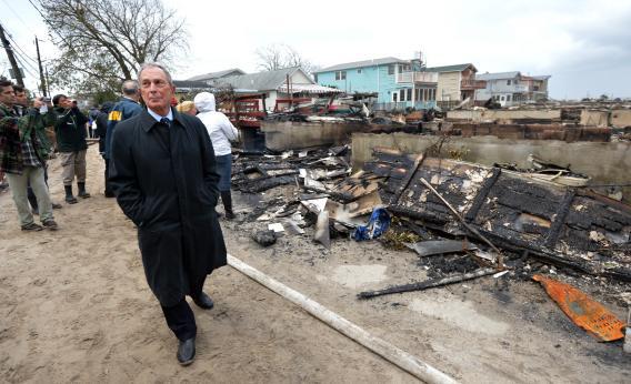 New York City Mayor Michael Bloomberg surveys the damage in Queens after fire destroyed about 80 homes as a result of Hurricane Sandy.