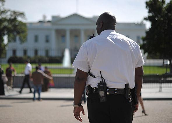 A member of the Security Service Uniformed Division keeps watch on Pennsylvania Avenue in front of the White House on September 23, 2014 in Washington, DC. 