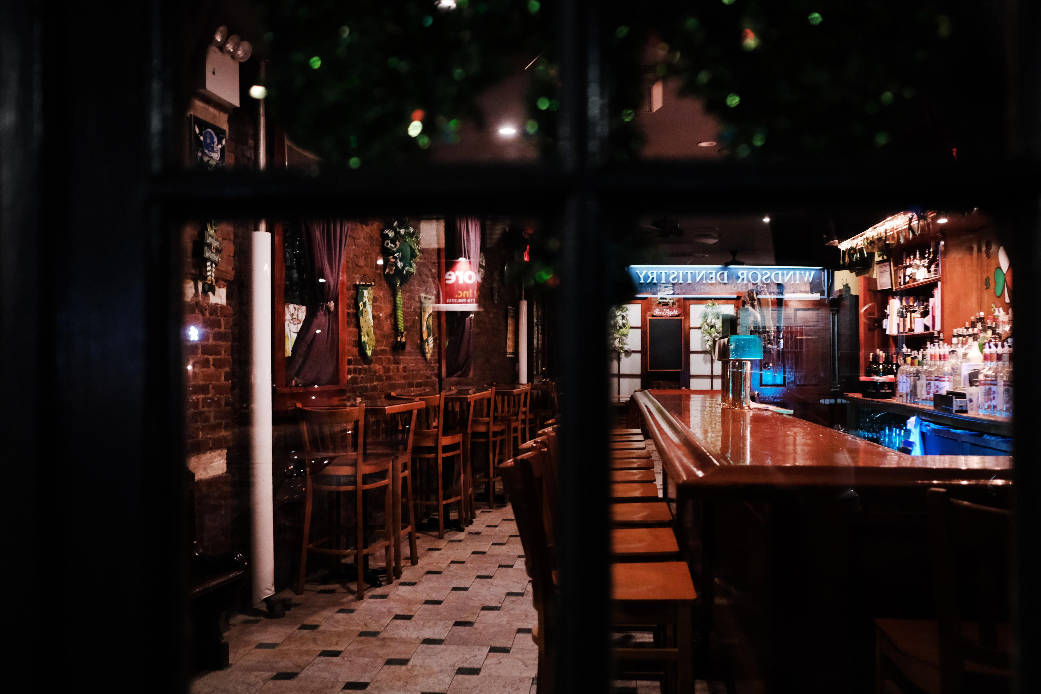 A dark, empty bar sits closed in New York on March 16.
