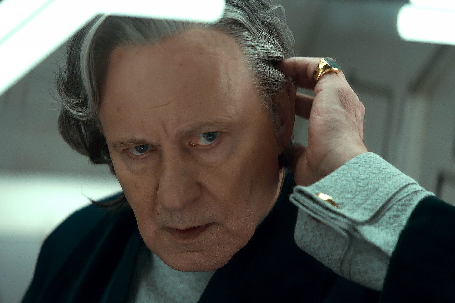 A gray-haired man looks worried.