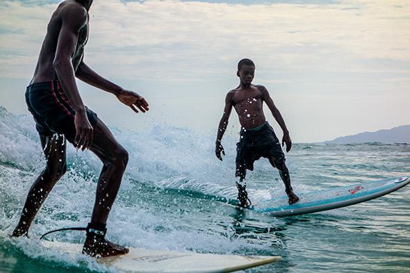 Two of the boys from Surf Haiti dodge share a wave, May 5, 2014.