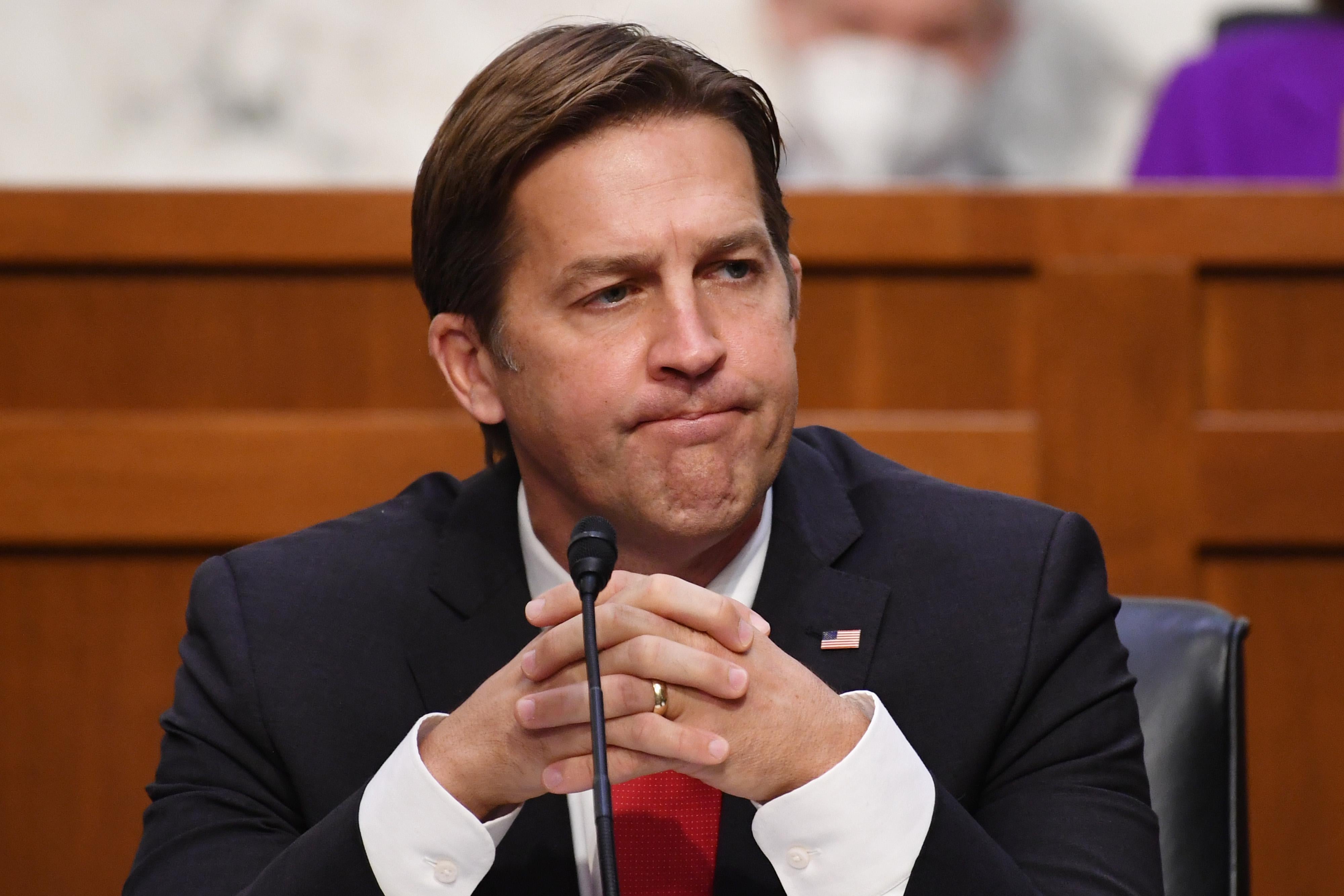 Ben Sasse purses his lips and holds his hands together.