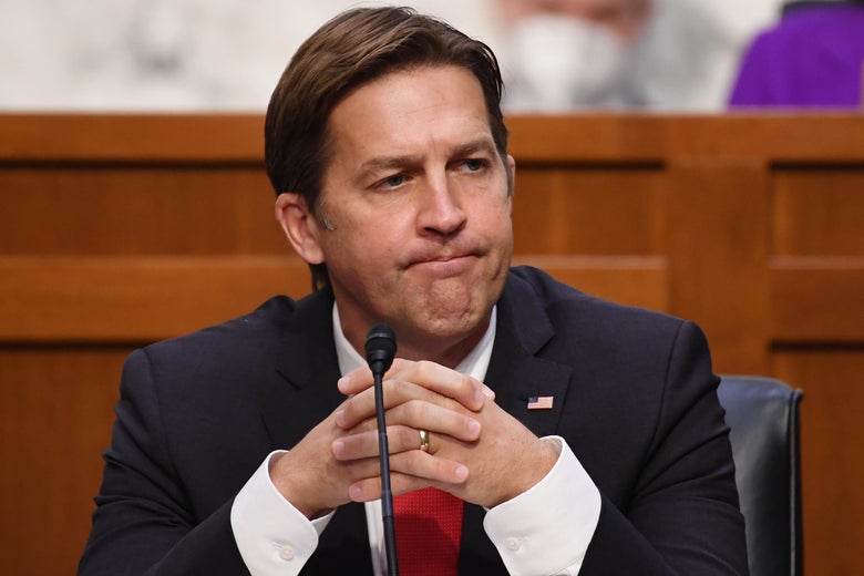 Ben Sasse purses his lips and holds his hands together.
