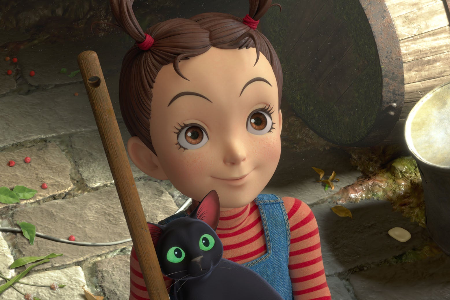 a young girl with pigtails on top of her head holds a black cat