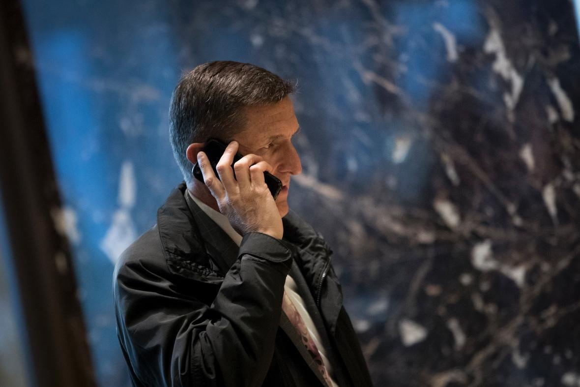 Michael Flynn holds a phone to his ear.