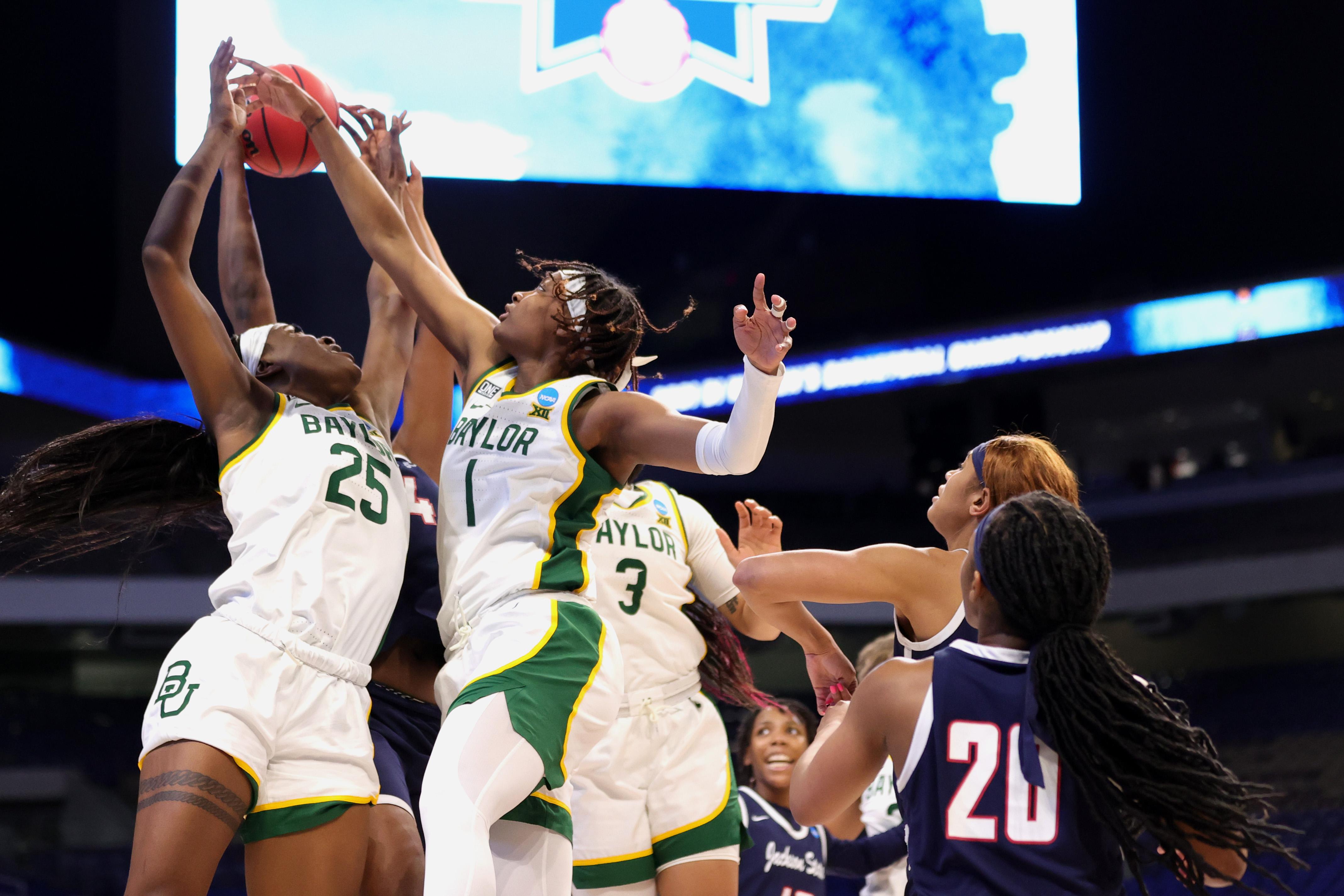 Queen Egbo #25 of the Baylor Lady Bears and NaLyssa Smith #1 go up for a rebound 