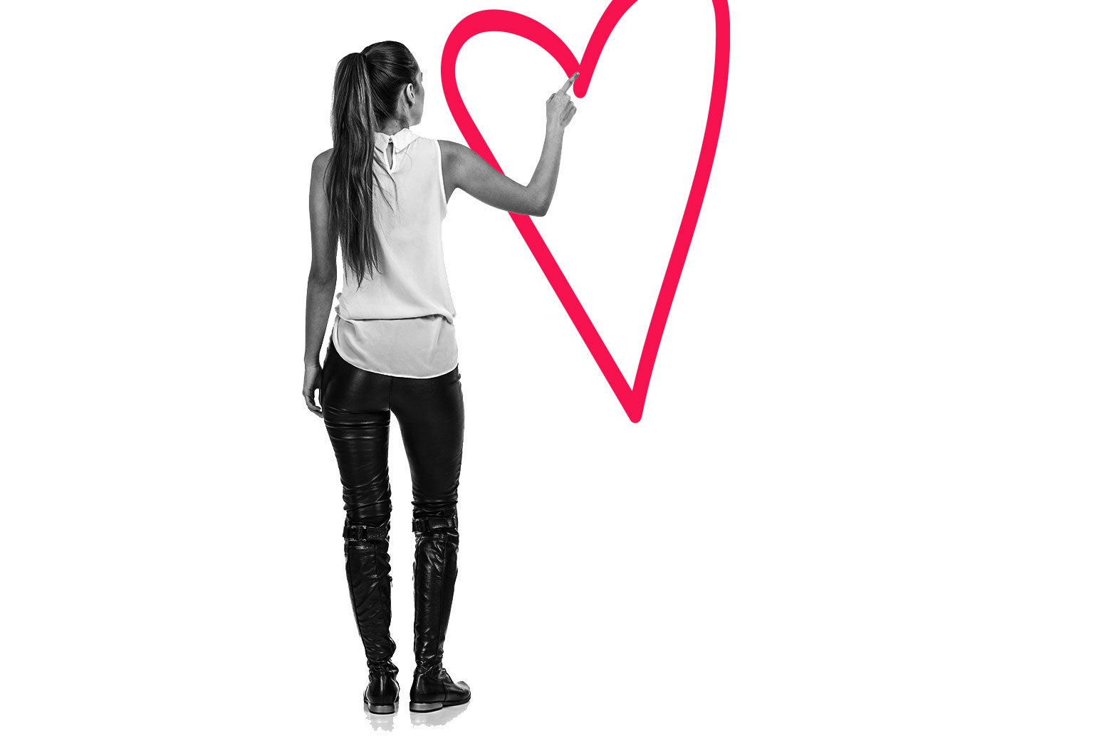 A person standing with their back to the camera draws an illustrated heart with their finger.