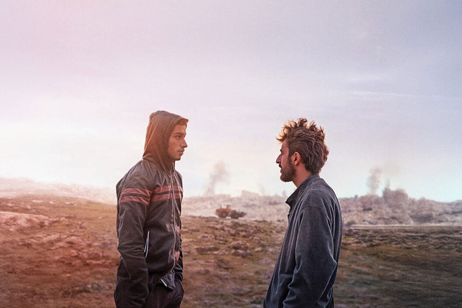 A still from No Other Land, which features a Palestinian man staring at an Israeli man.