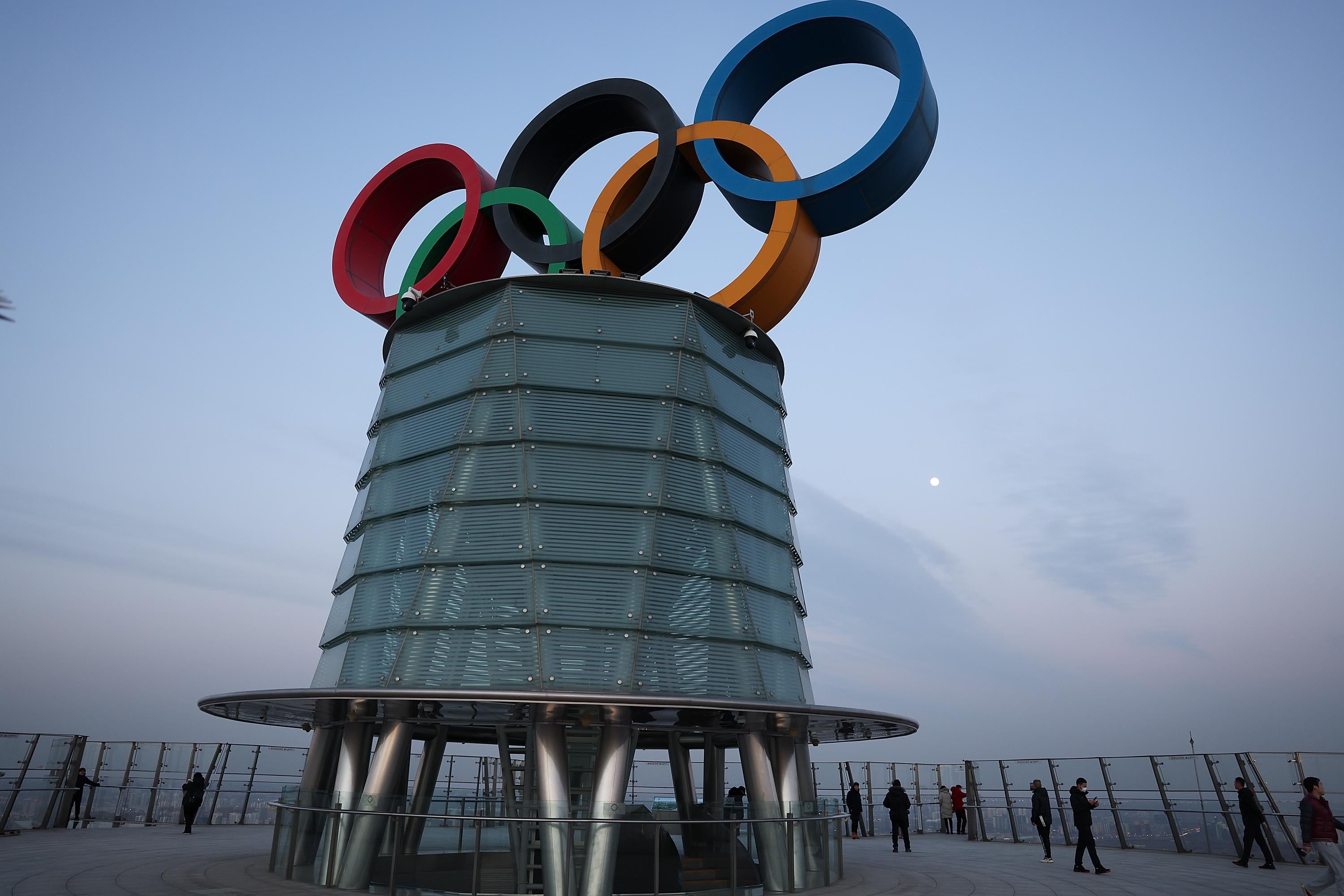 Visitors pose for photographs with the Olympic rings at the Beijing Olympic Tower on January 16, 2022 in Beijing, China.
