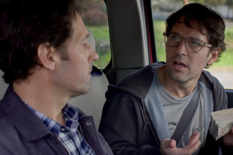 Clean-shaven Paul Rudd listens to a messier Paul Rudd while they both sit in a car in this still from Living With Yourself.