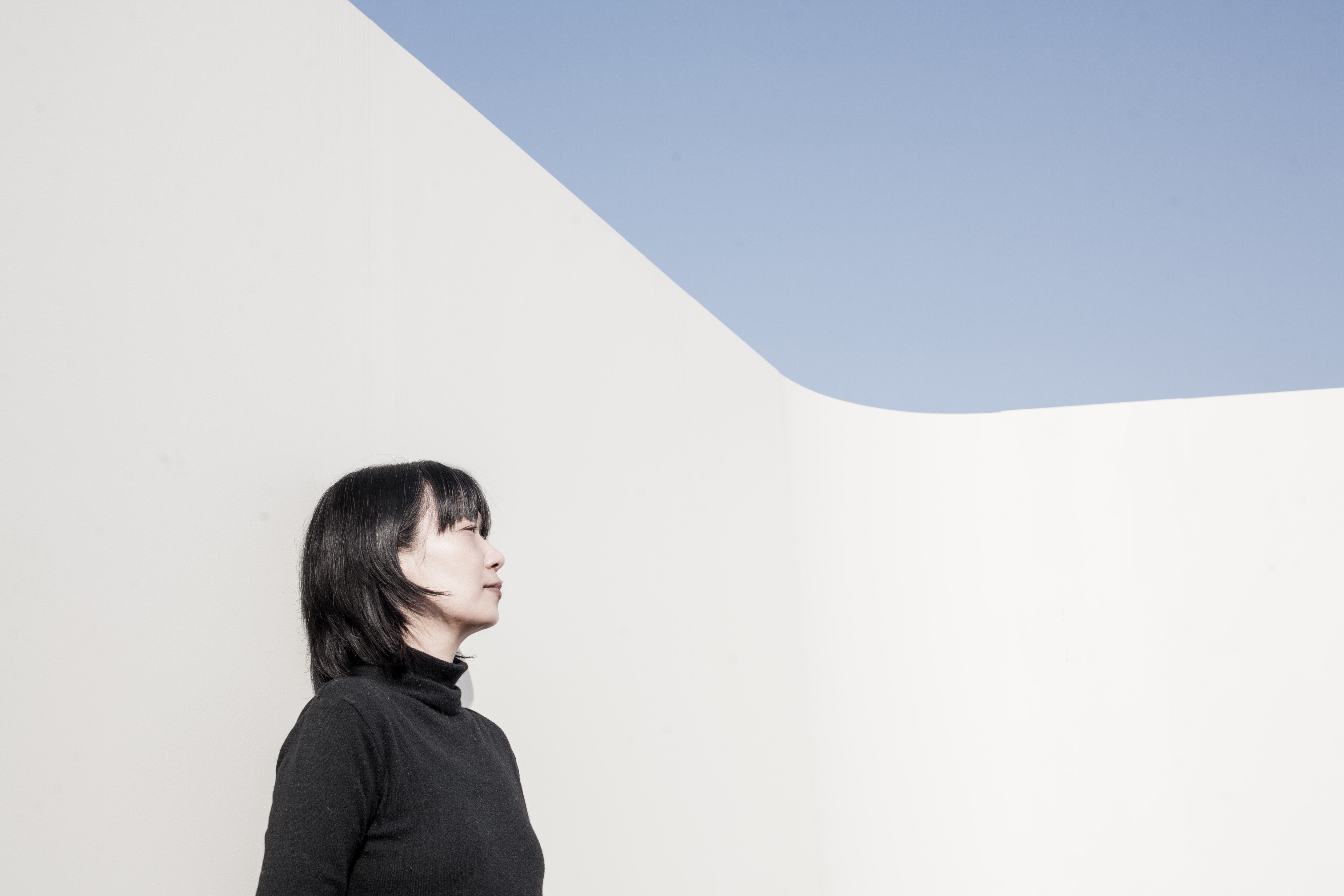 The author Han Kang, a woman with dark hair and bangs, wearing a black turtleneck.