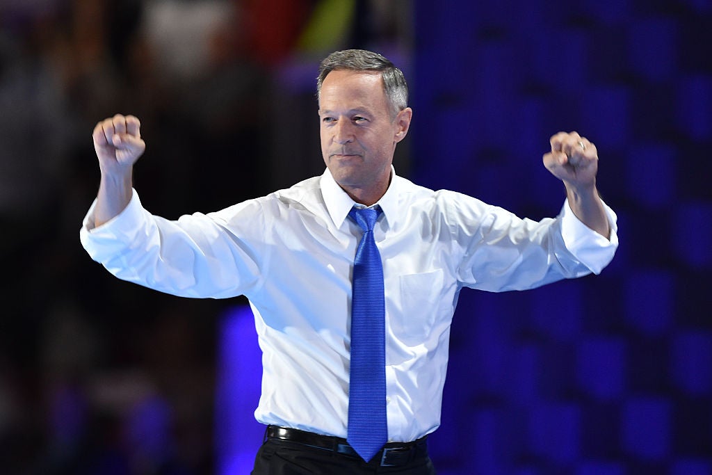 Martin O'Malley, in shirtsleeves and a purple tie, pumps his fists.