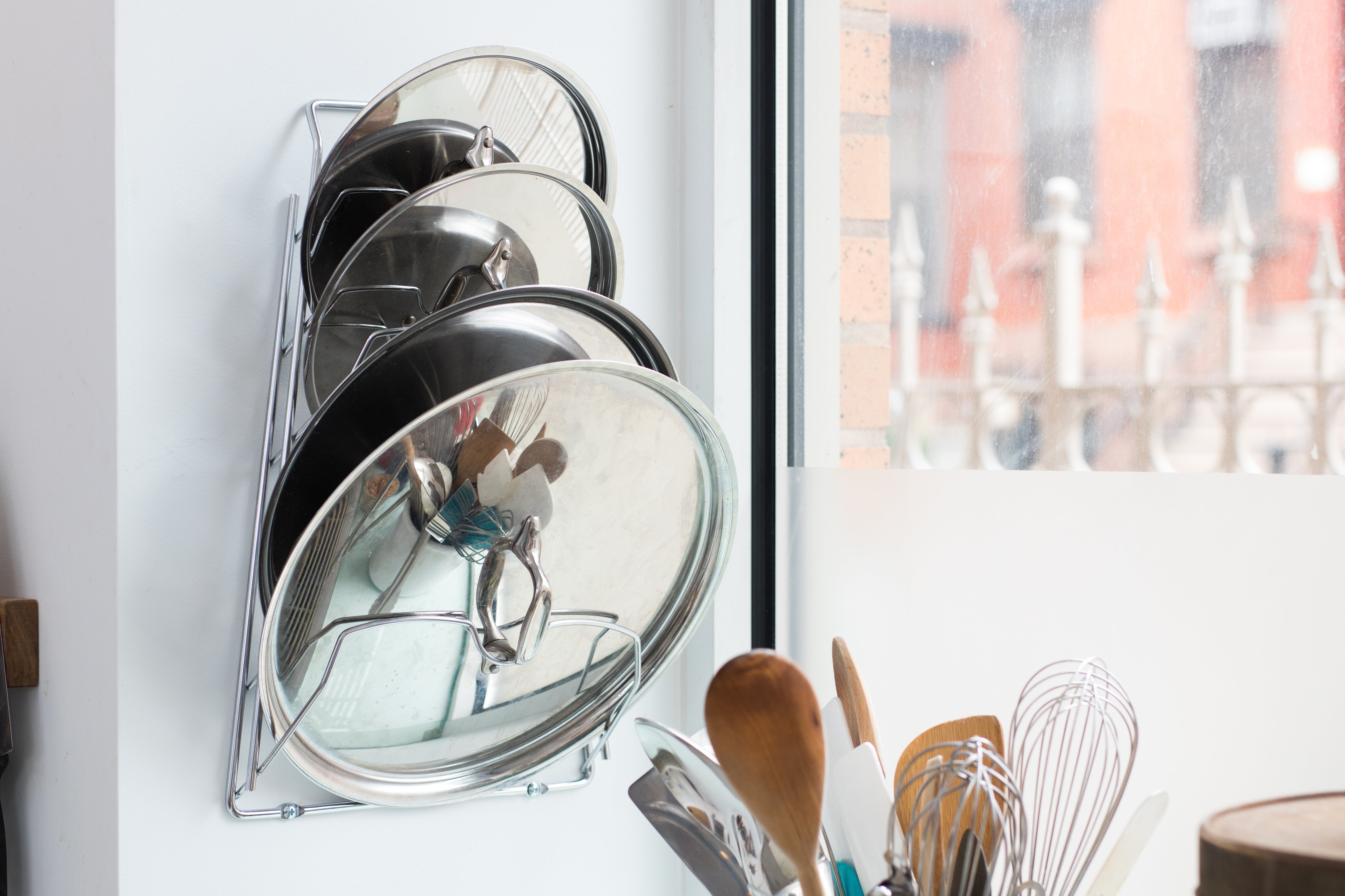 The Organize It All rack with pot lids in it.