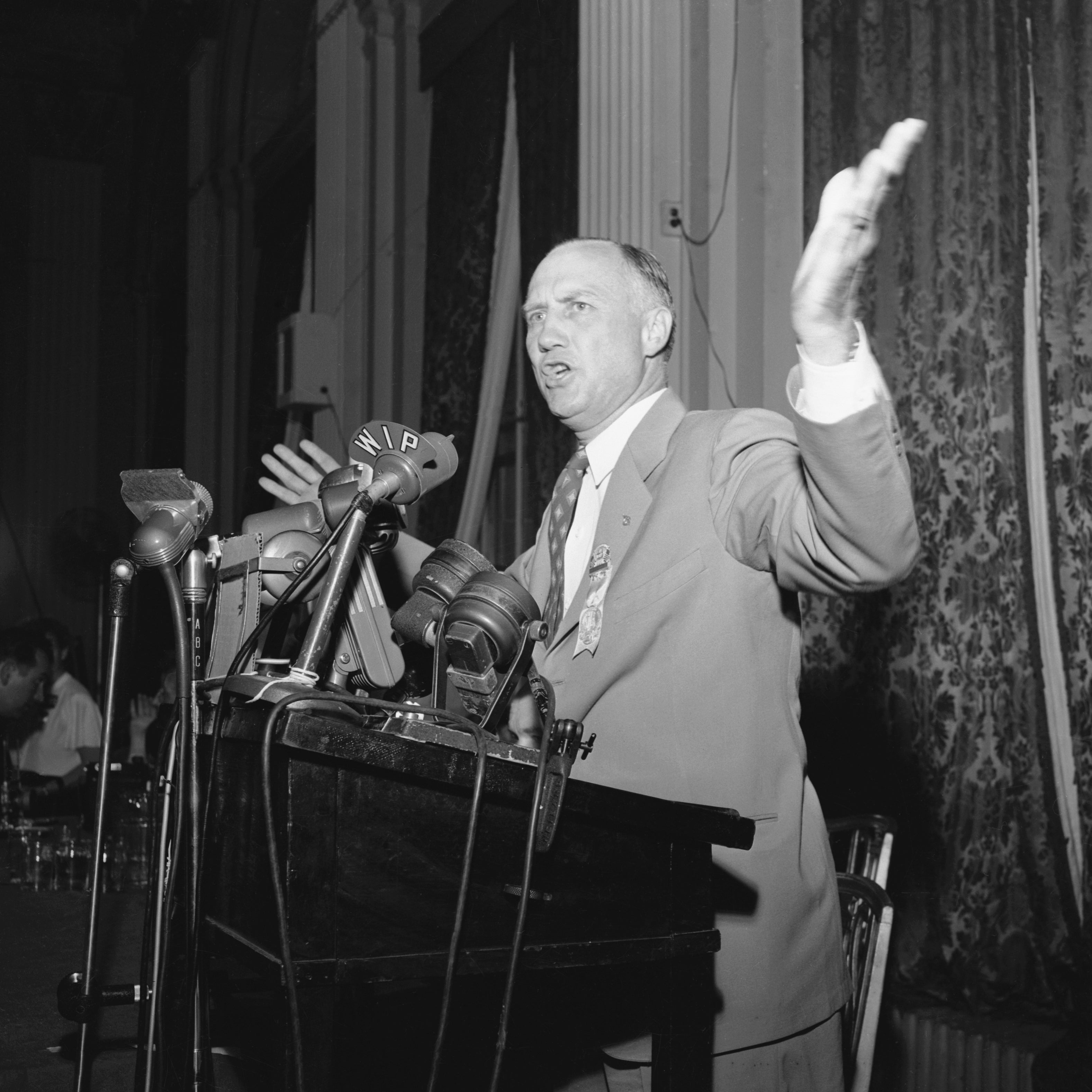 Thurmond speaking at a podium in front of a bunch of microphones