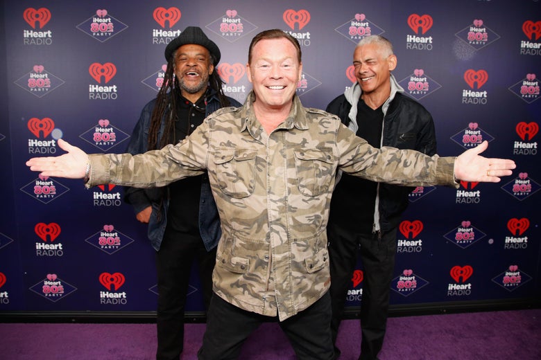 Astro, Ali Campbell, and Mickey Virtue, looking happy.
