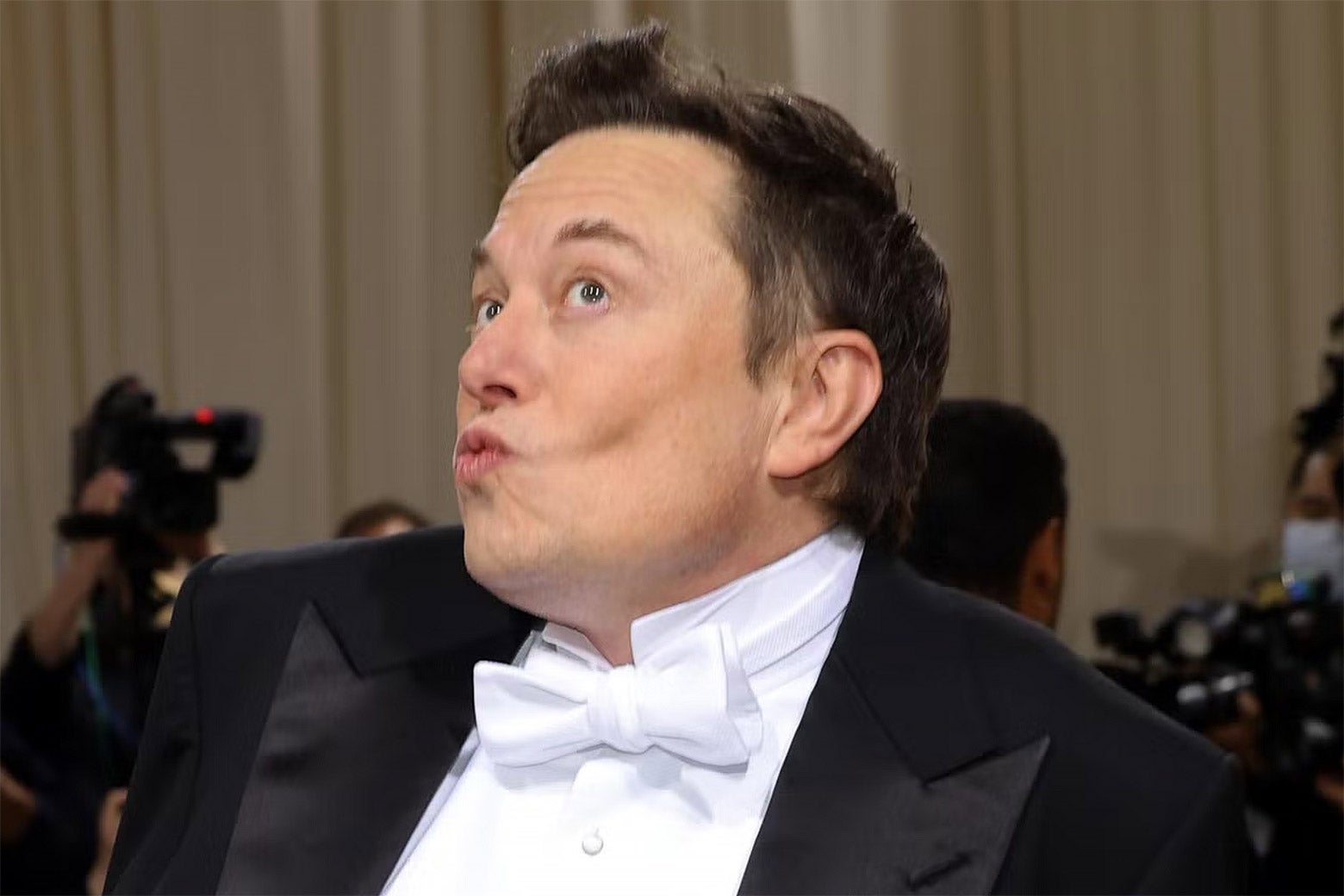 Elon Musk puckering his lips.