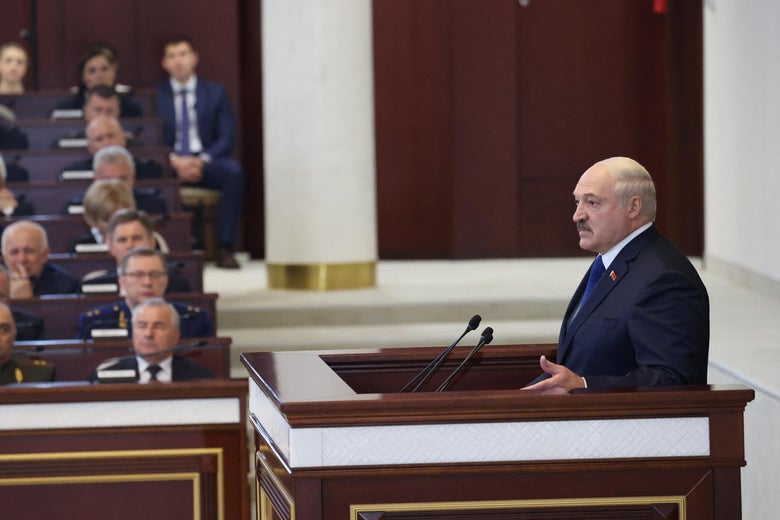 Belarusian President Alexander Lukashenko speaks from a podium in parliament.