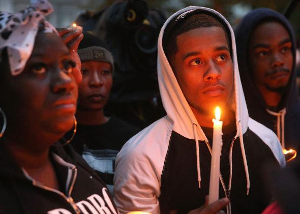 Mourners attend a candlelight vigil in memory of 18-year-old Vonderrit Myers Jr. on October 9, 2014 in St Louis, Missouri. 