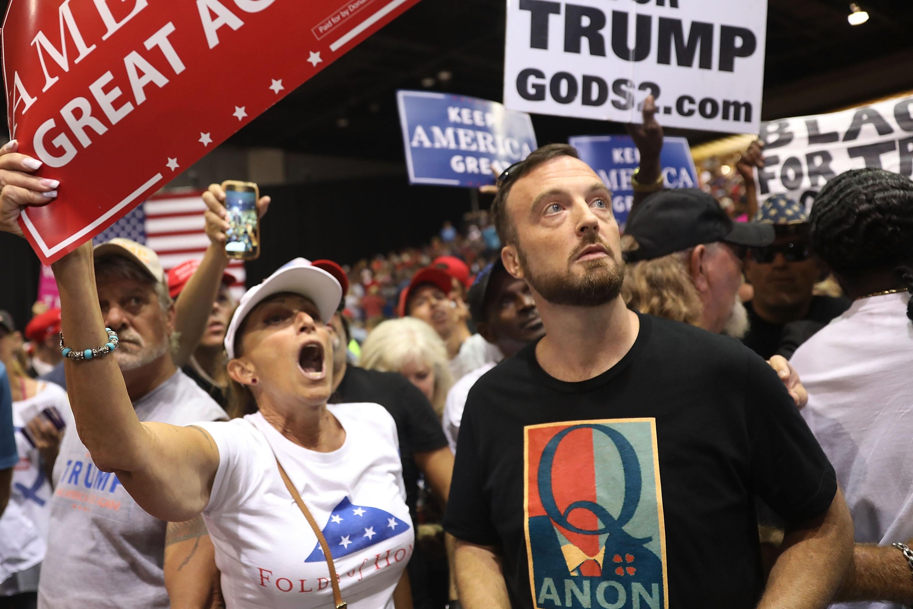TAMPA, FL - JULY 31:  A man wear a shirt with the words Q Anon as he attends a rally for President Donald Trump at the Make America Great Again Rally being held in the Florida State Fair Grounds Expo Hall on July 31, 2018 in Tampa, Florida.  Some people attending either wore shirts with a Q or held signs with a Q and are reported to be part of a conspiracy theory group.  (Photo by Joe Raedle/Getty Images)