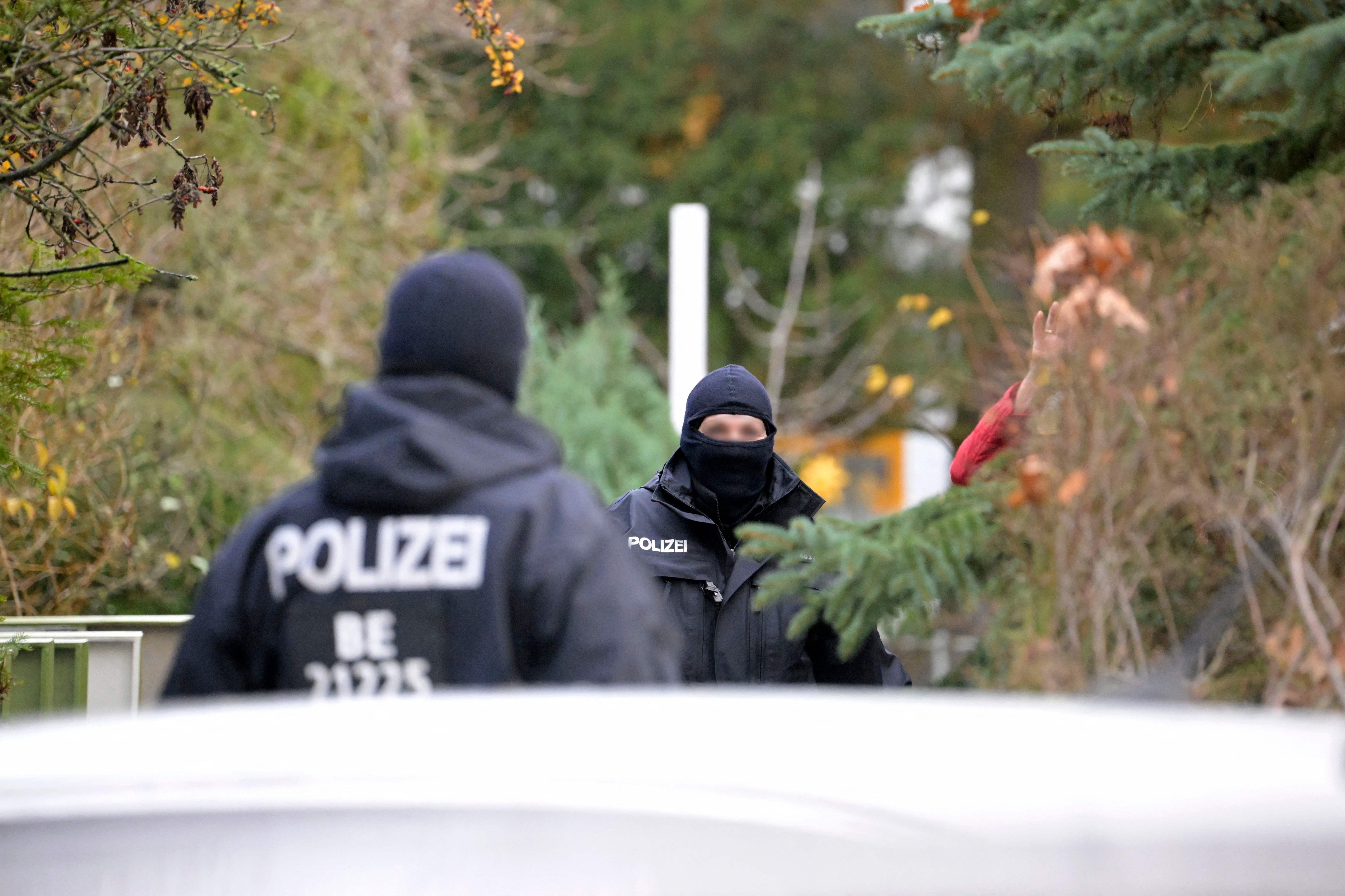 Police officers are seen during a raid on December 7, 2022 in Berlin that is part of nationwide early morning raids against members of a far-right "terror group" suspected of planning an attack. - During the nationwide raids, police arrested 25 people suspected of belonging to a far-right "terror cell" plotting to overthrow the government and attack parliament. Around 3,000 officers including elite anti-terror units took part in the early morning raids and searched more than 130 properties, in what German media described as one of the country's largest police actions ever against extremists. (Photo by Tobias SCHWARZ / AFP) (Photo by TOBIAS SCHWARZ/AFP via Getty Images)
