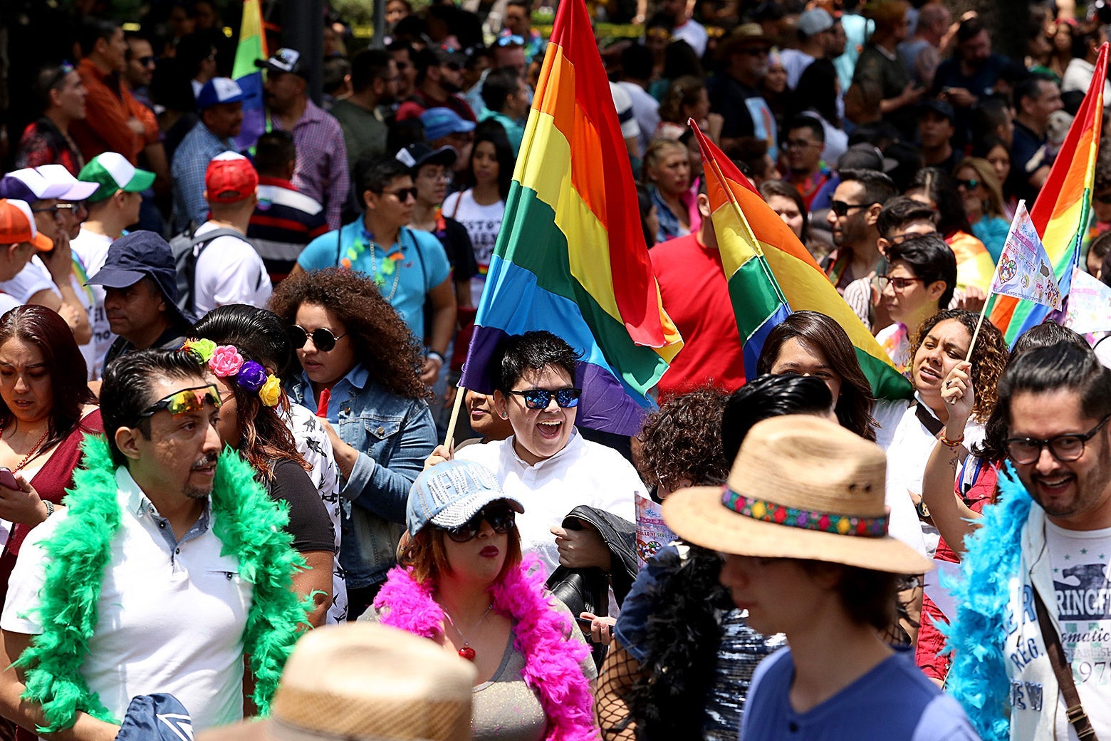 People walk and dance during a Pride parade in Mexico City.