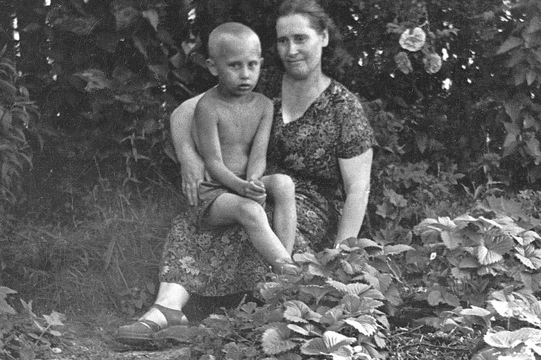 Vladimir Putin with his "real" mother, Maria Ivanovna Putina, as a boy. 

