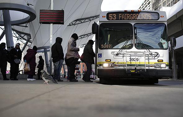 Commuters board the 53 Woodward bus at the Rosa Parks bus terminal January 1, 2015 in Detroit, Michigan. 