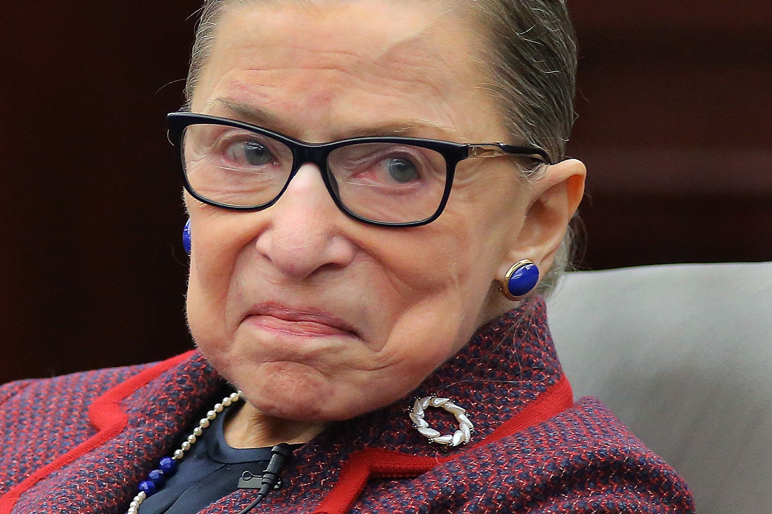 A close-up of Ruth Bader Ginsburg with a slight, close-mouthed smile.
