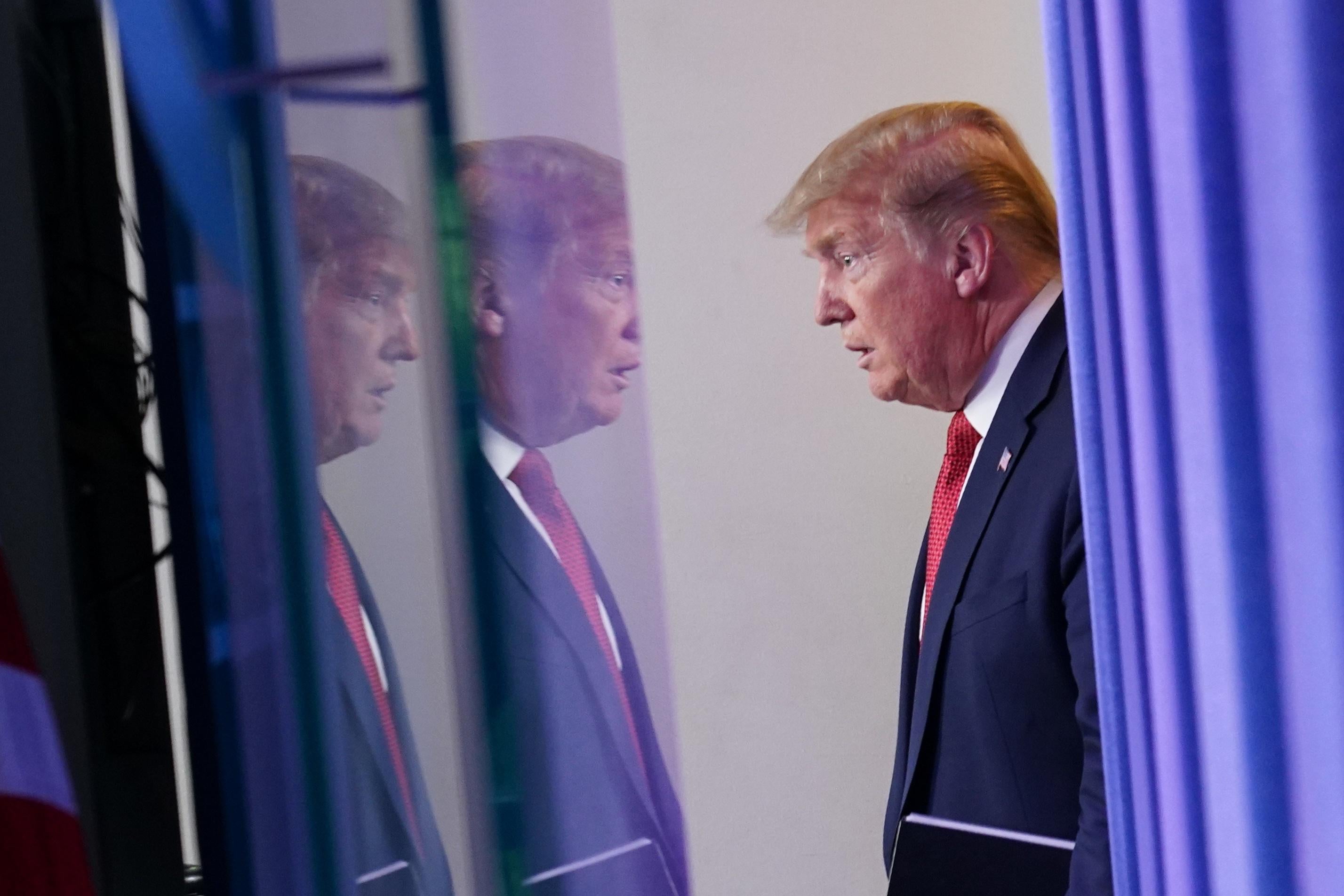 Donald Trump reflected across two screens.