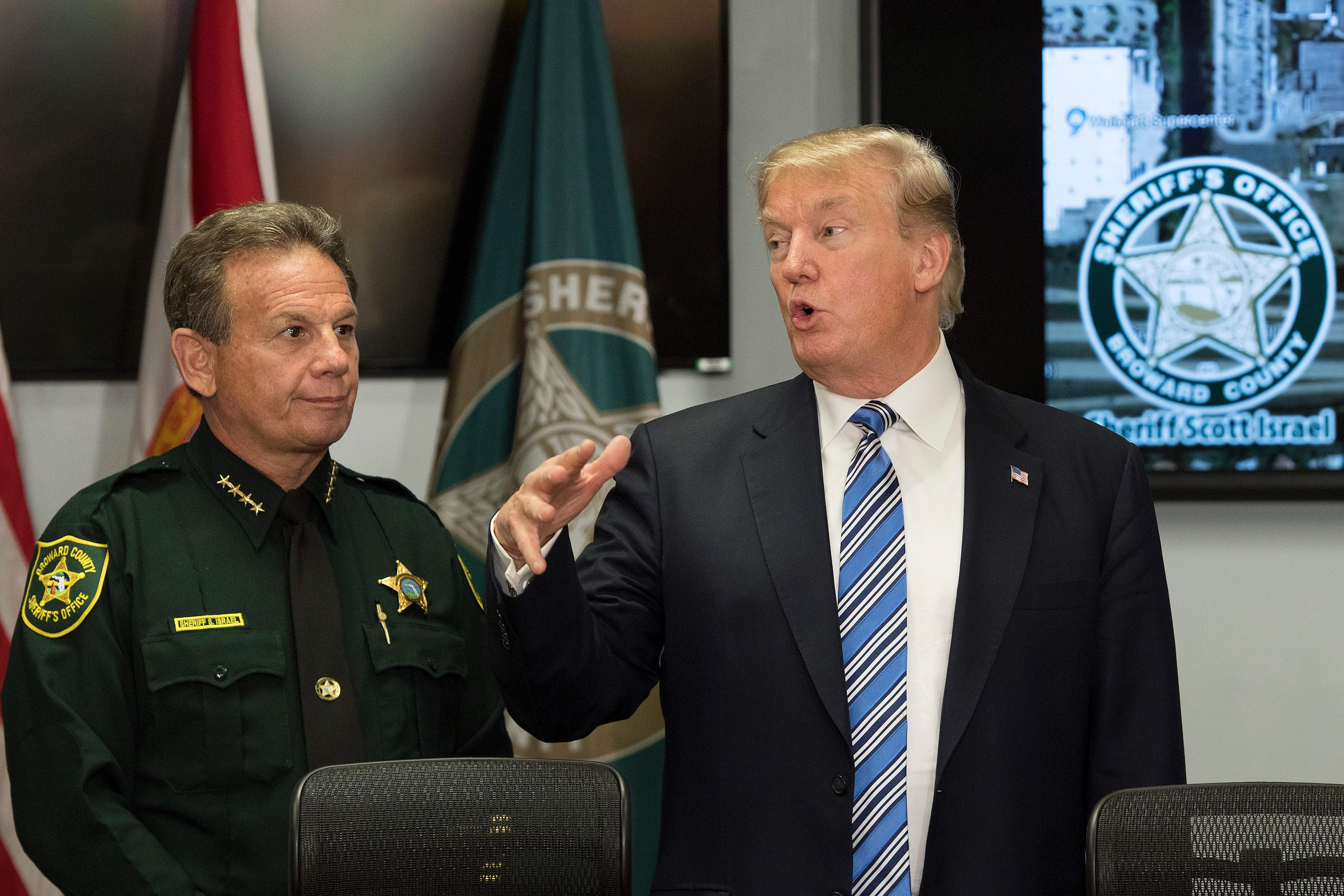 US President Donald Trump (R) speaks with Broward County Sheriff Scott Israel (L) while visiting first responders at Broward County Sheriff's Office in Pompano Beach, Florida, on February 16, 2018, three days after a mass shooting that claimed 17 lives at a nearby high school.