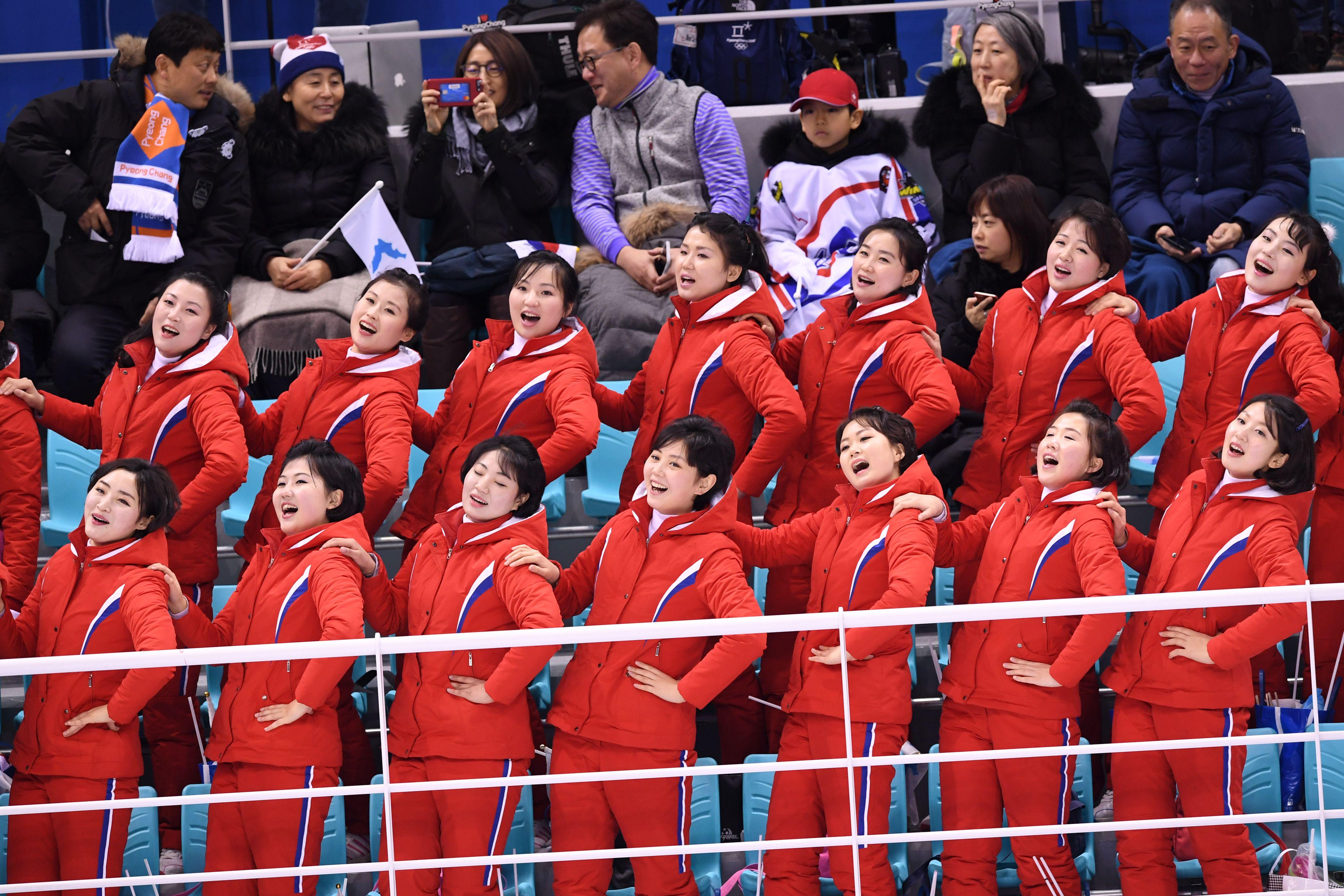 North Korea's cheerleaders cheer during the women's preliminary round ice hockey match between Switzerland and the Unified Korean team during the Pyeongchang 2018 Winter Olympic Games at the Kwandong Hockey Centre in Gangneung on February 10, 2018.   / AFP PHOTO / JUNG Yeon-Je        (Photo credit should read JUNG YEON-JE/AFP/Getty Images)