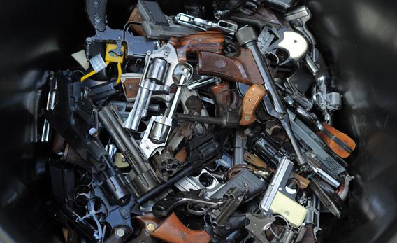 A trash bin full of handguns collected during the LAPD Gun Buyback Program.