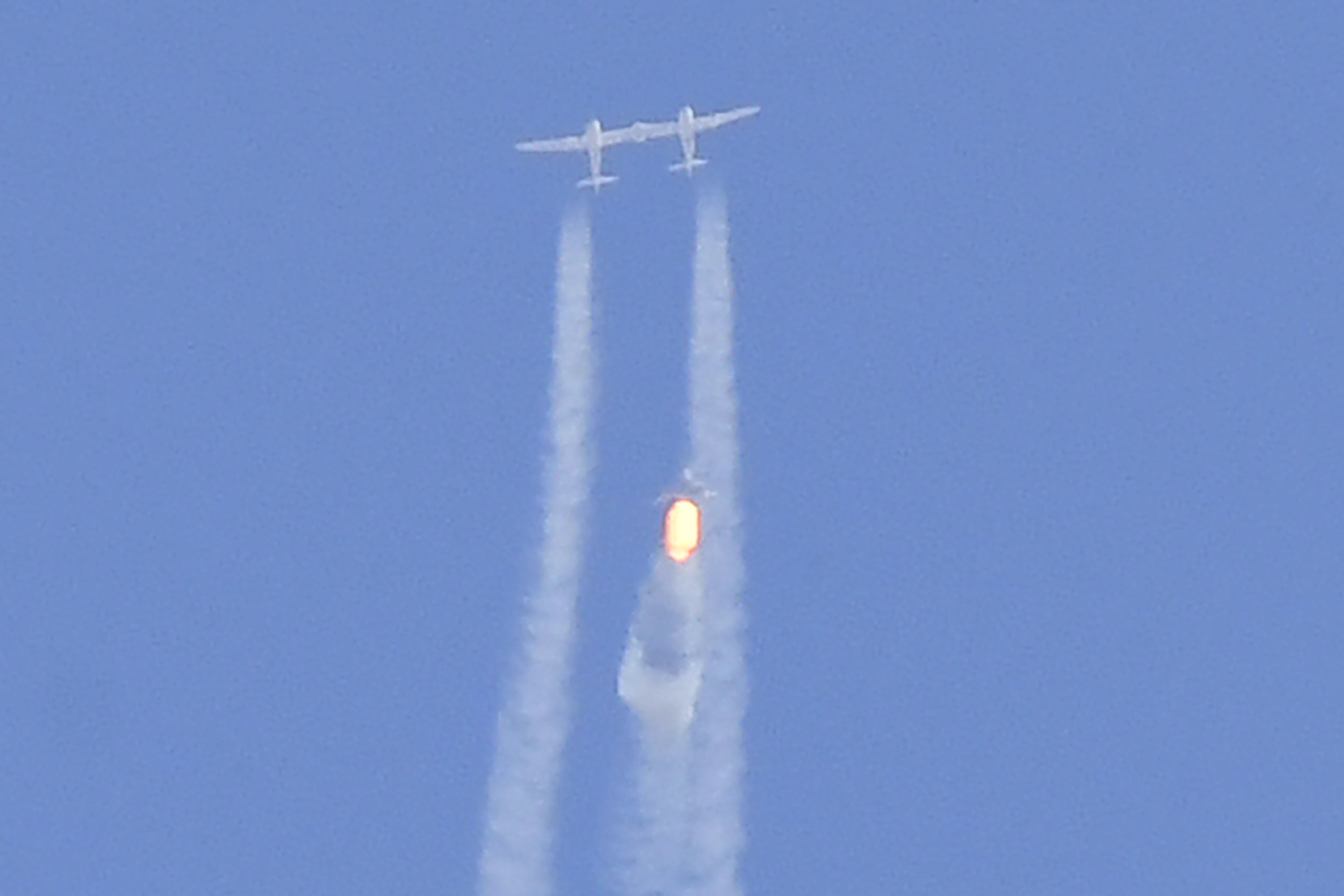The Virgin Galactic SpaceShipTwo space plane Unity and mothership separate as they fly way above Spaceport America, near Truth and Consequences, New Mexico on July 11, 2021 on the way to the cosmos.