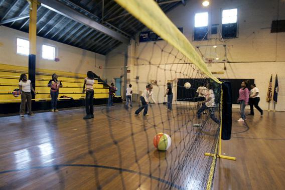 Students play in the school gym which is over seventy years old and has a roof that leaks at J.V. Junior High School in Dillon, South Carolina.
