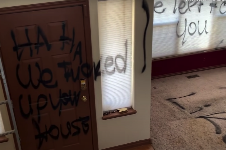 A door spray-painted "ha ha we fucked up your house."