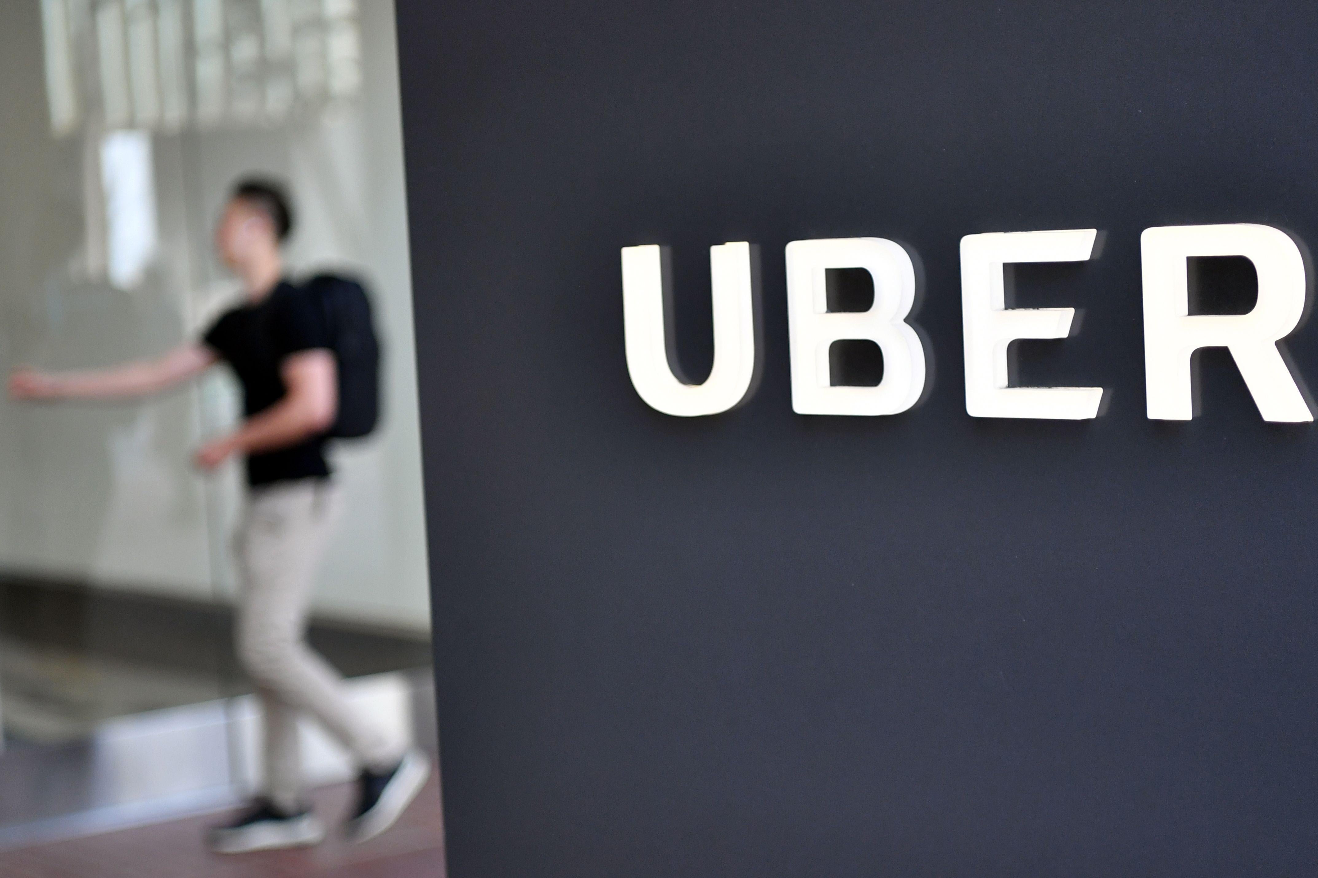 A man walks into the Uber Corporate Headquarters building in San Francisco, California on February 05, 2018. 
The billion-dollar trial pitting Alphabet-owned autonomous driving unit Waymo against Uber started in what could be a blockbuster case between two technology giants over alleged theft of trade secrets. The San Francisco courtroom battle will take place as Waymo and Uber race to perfect self-driving cars that people could summon for rides as desired in a turn away from car ownership.
 / AFP PHOTO / JOSH EDELSON        (Photo credit should read JOSH EDELSON/AFP/Getty Images)