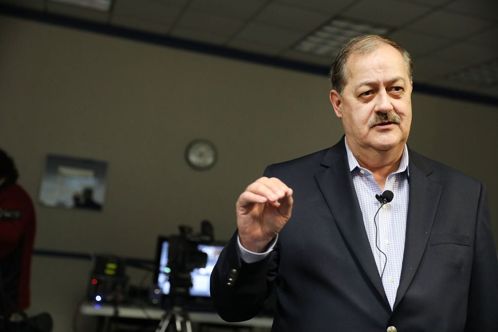 Don Blankenship speaks while wearing a microphone on his lapel.