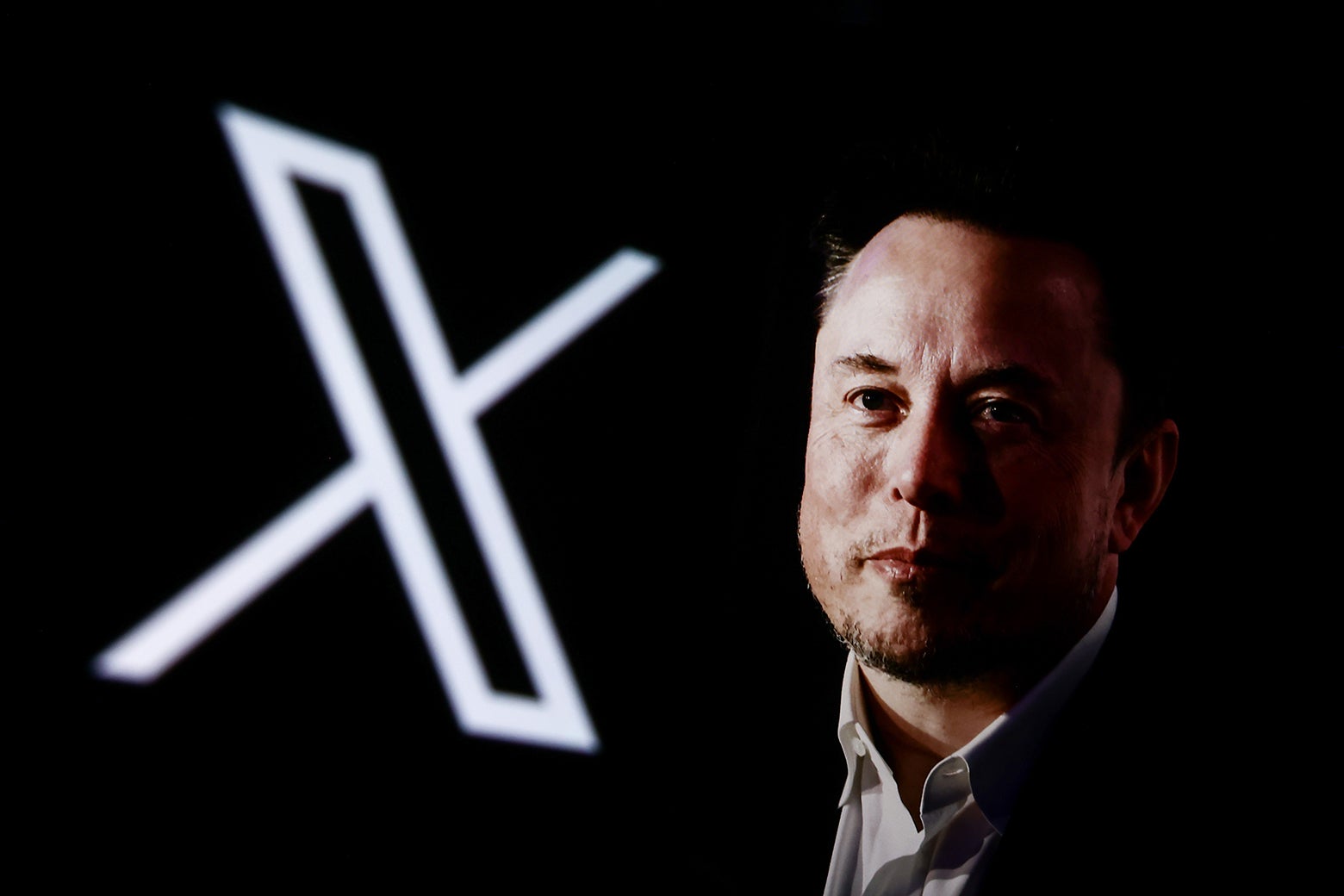Elon Musk in front of the X logo.