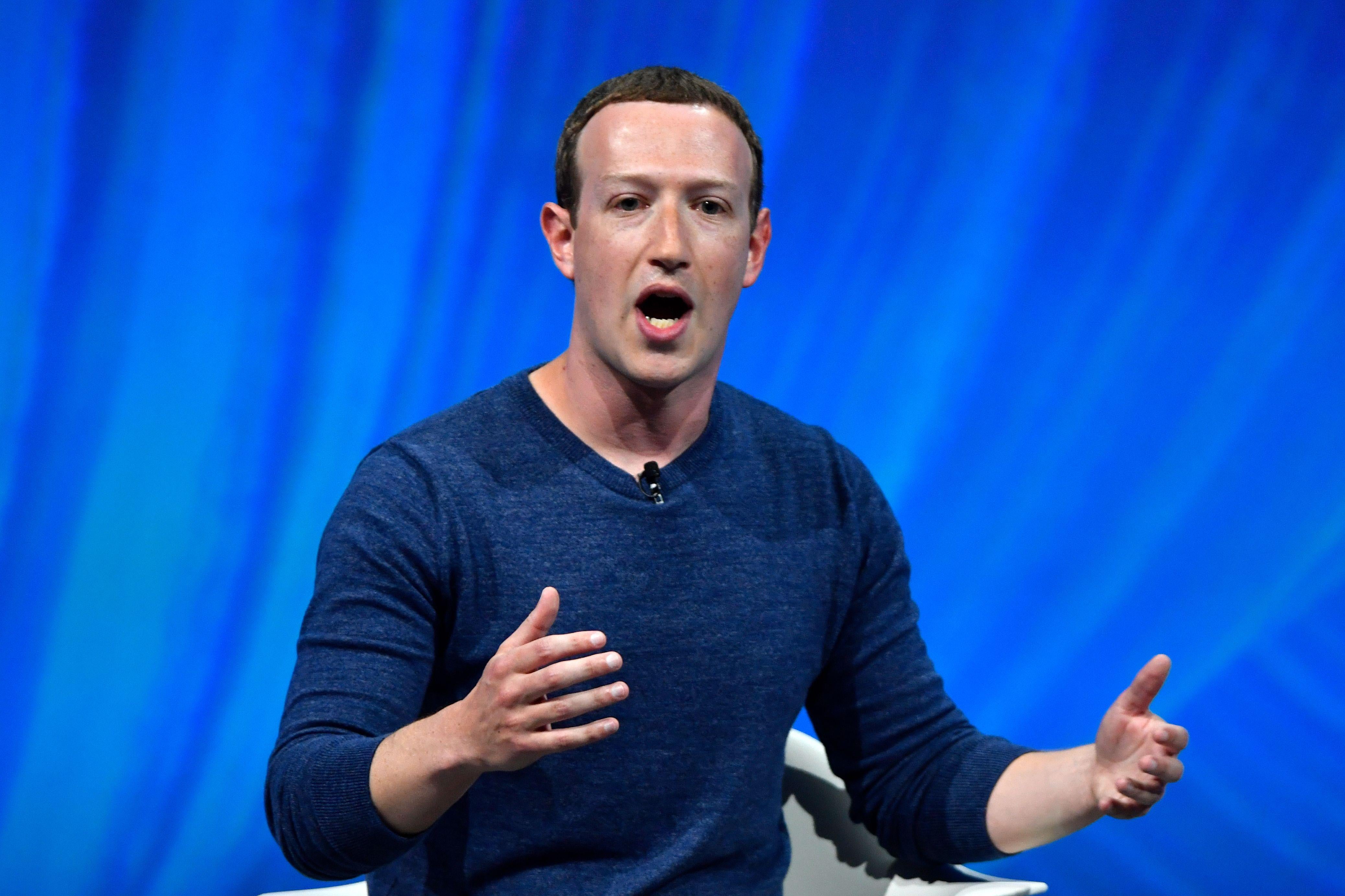 Mark Zuckerberg gestures while speaking at an event.
