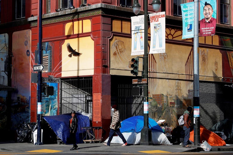 Tents set up by homeless people are seen on a corner street as people walk by, in San Francisco's Tenderloin.