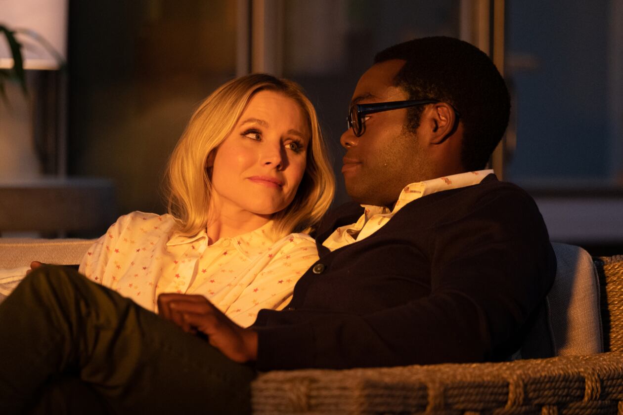 Chidi and Eleanor sit on the couch, staring lovingly into each other's eyes, in the light of the golden hour