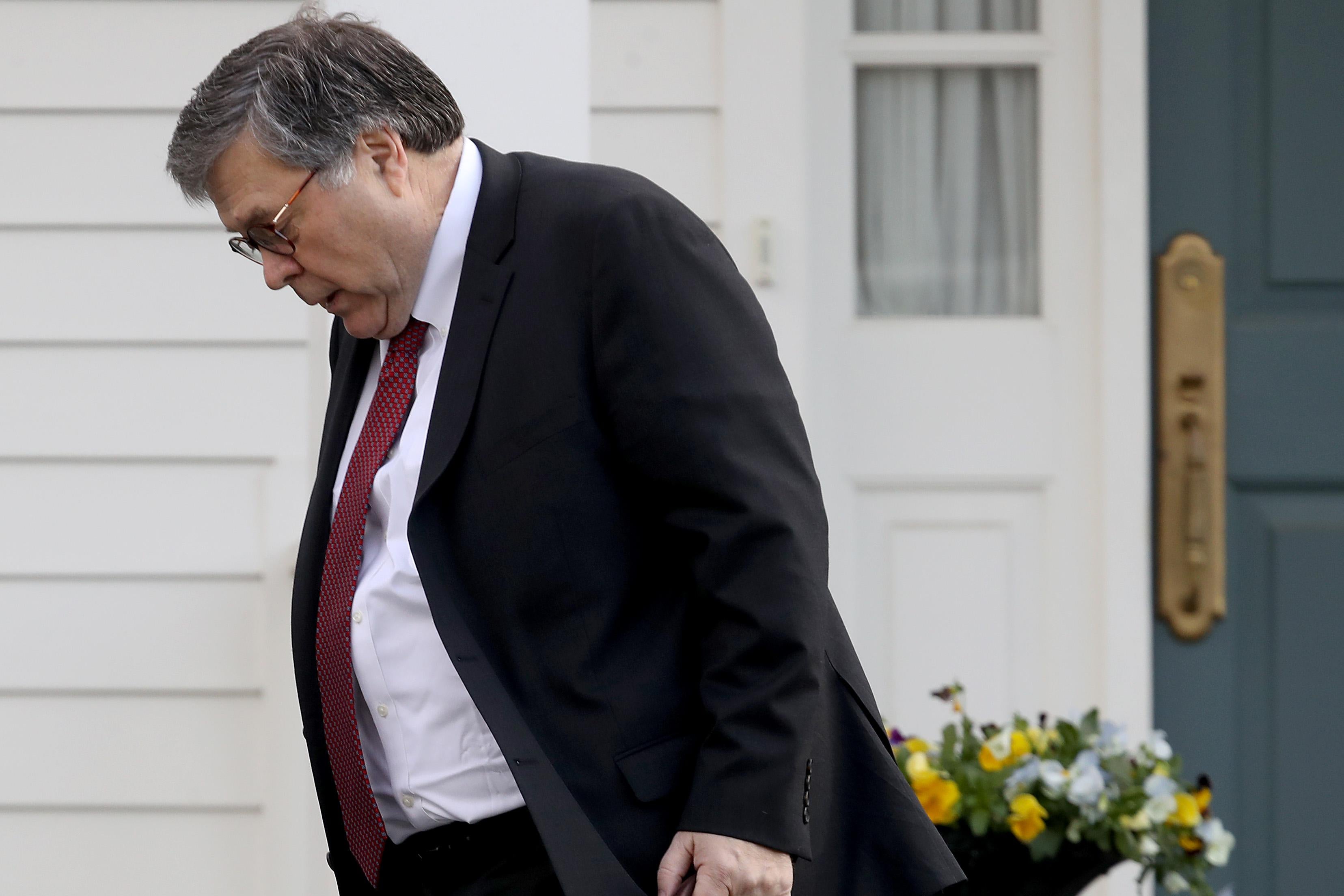 William Barr walking outside his house 