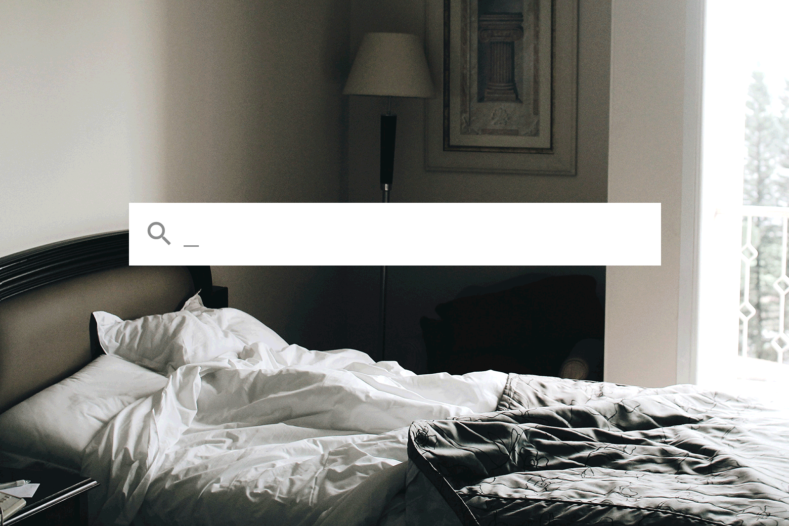 GIF of a slightly unmade bed with a search bar across it and a blinking cursor