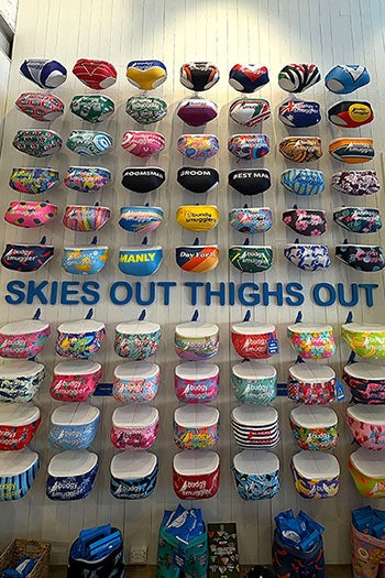 A wall that reads Skies Out, Thighs with a large selection of Budgy Smuggler underwear.