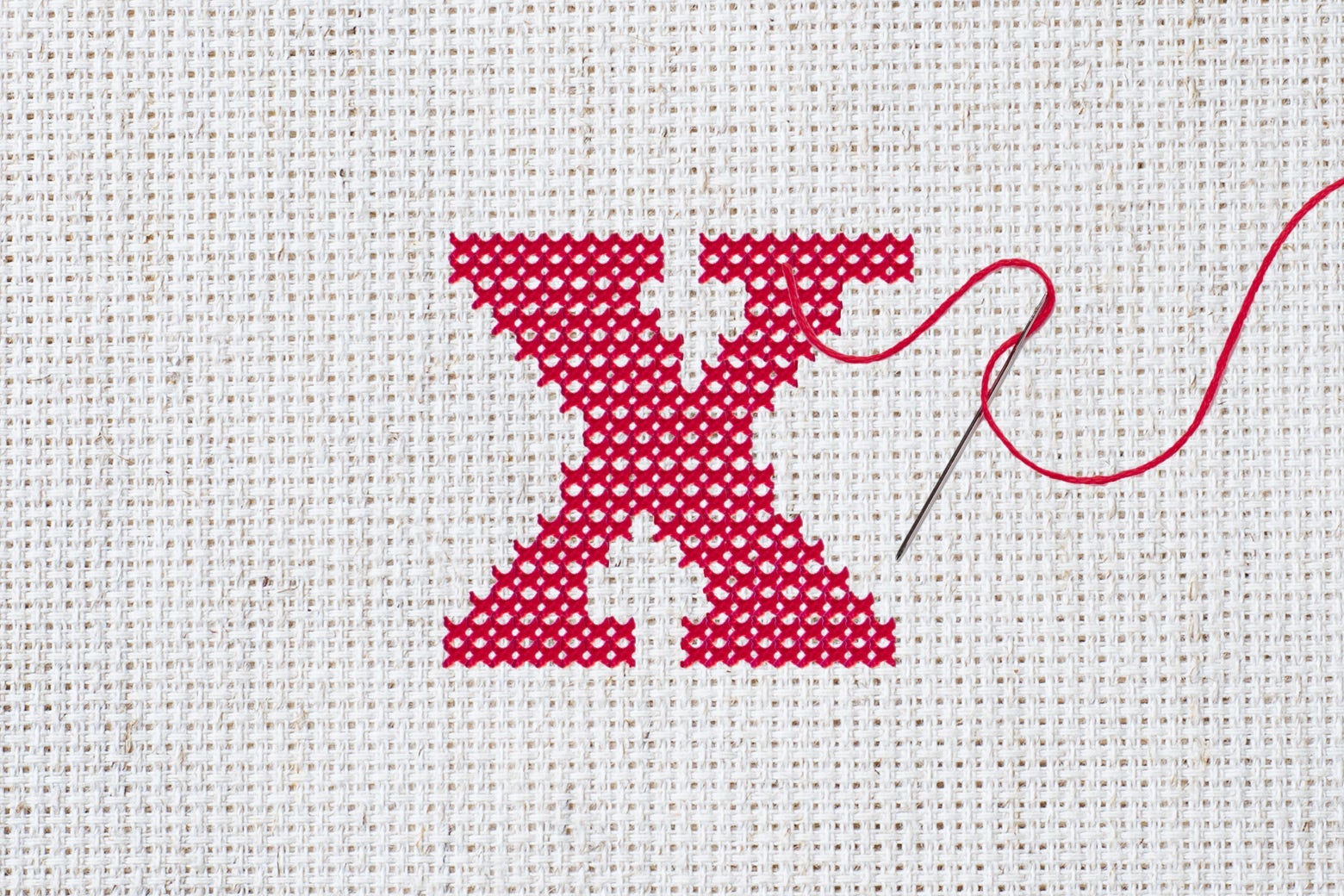 A cross-stitched red X.